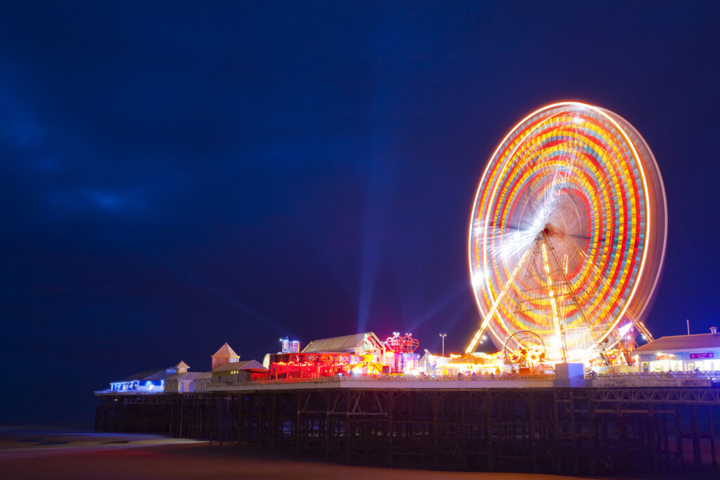 England, Lancashire, Blackpool. Blackpool Central Pier at night, illuminated as part of the Blackpool Illuminations.