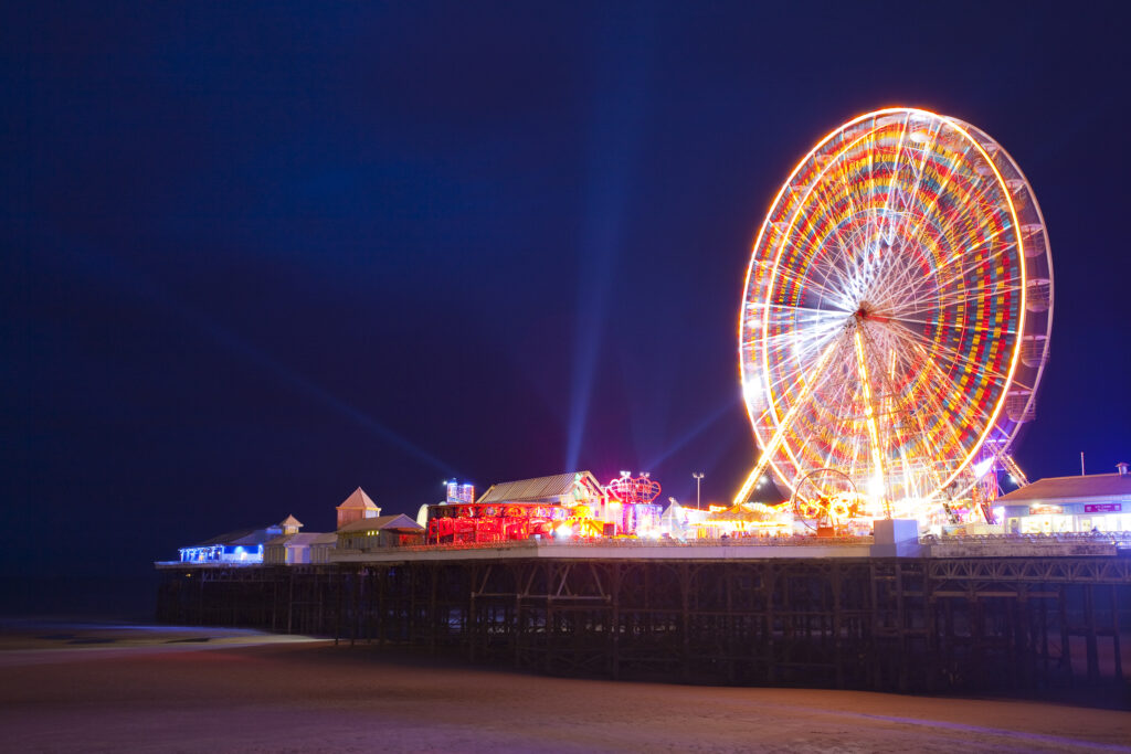 England, Lancashire, Blackpool. Blackpool Central Pier at night, illuminated as part of the Blackpool Illuminations.