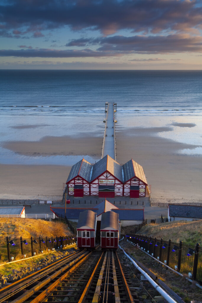England, Cleveland, Saltburn-by-the-Sea. View from the top of the funicular railway, one of the world's oldest water-powered cliff lifts, towards the Victorian Pier and North Sea Beach.