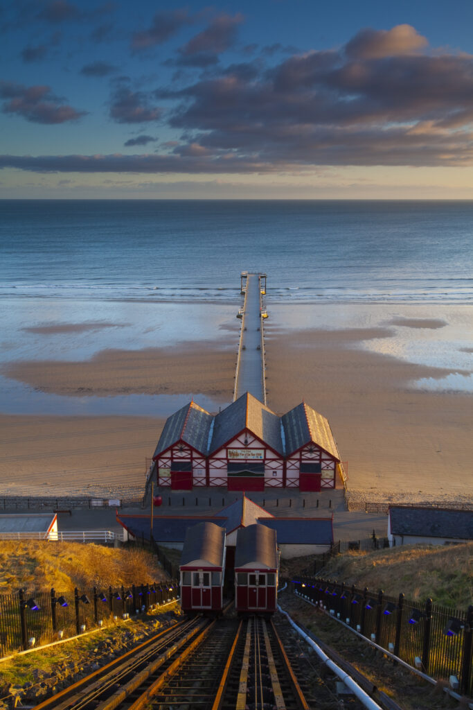 England, Cleveland, Saltburn-by-the-Sea. View from the top of the funicular railway, one of the world's oldest water-powered cliff lifts, towards the Victorian Pier and North Sea Beach.