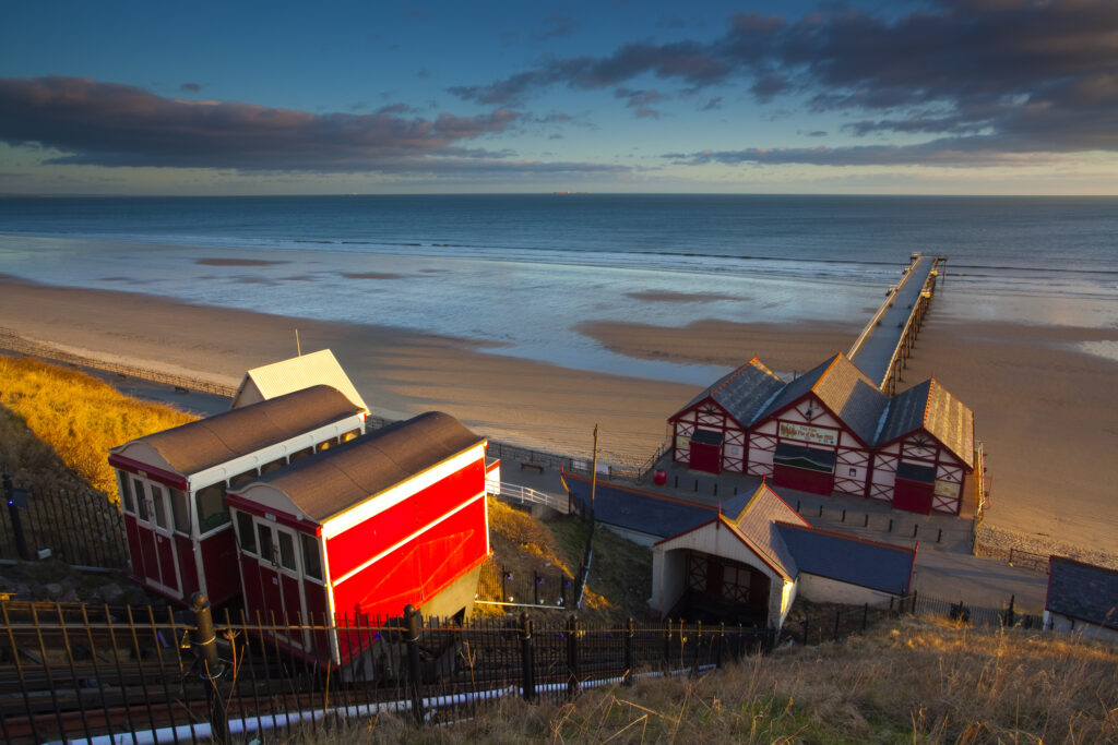 England, Cleveland, Saltburn-by-the-Sea. View from the top of the funicular railway, one of the world's oldest water-powered cliff lifts, towards the Victorian Pier and North Sea Beach.