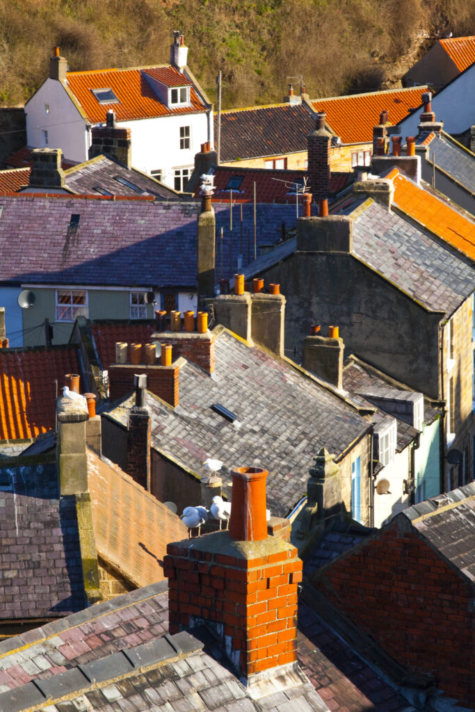 England, North Yorkshire, Staithes. View looking down on the roofs and chimney pots of the old town of Staithes, located within the North York Moors National Park.