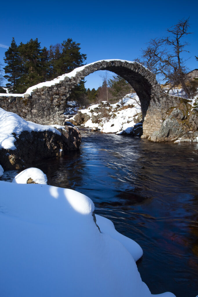 Scotland, Scottish Highlands, Cairngorms National Park. Old stone packhorse bridge over the River Dulnain at Carrbridge, The bridge was built in 1717 and is believed to be the oldest stone bridge to be found in the Highlands.