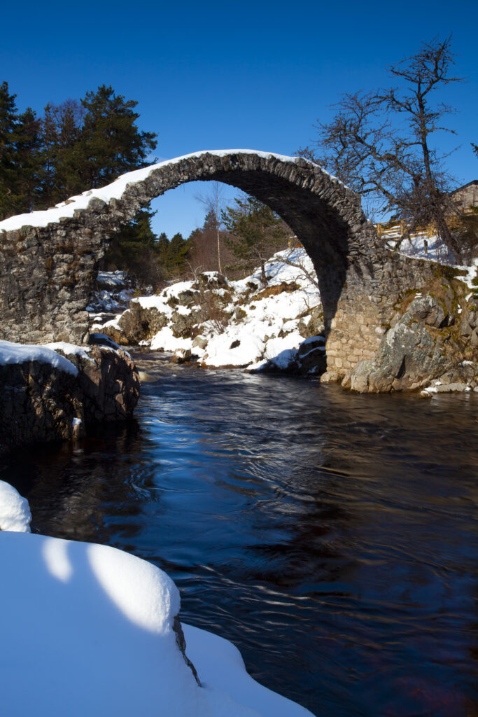 Scotland, Scottish Highlands, Cairngorms National Park. Old stone packhorse bridge over the River Dulnain at Carrbridge, The bridge was built in 1717 and is believed to be the oldest stone bridge to be found in the Highlands.