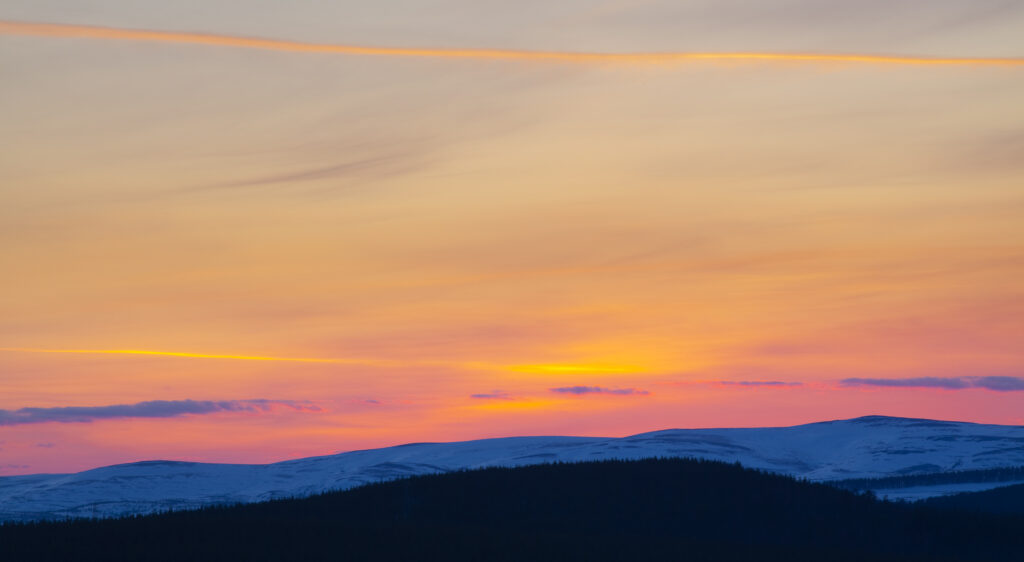 Scotland, Scottish Highlands, Cairngorms National Park. View from the the Old Military Road (now part of the A939) from near the Bridge of Brown looking across a snow covered valley towards the mountain peaks of the Cairngorms National Park.