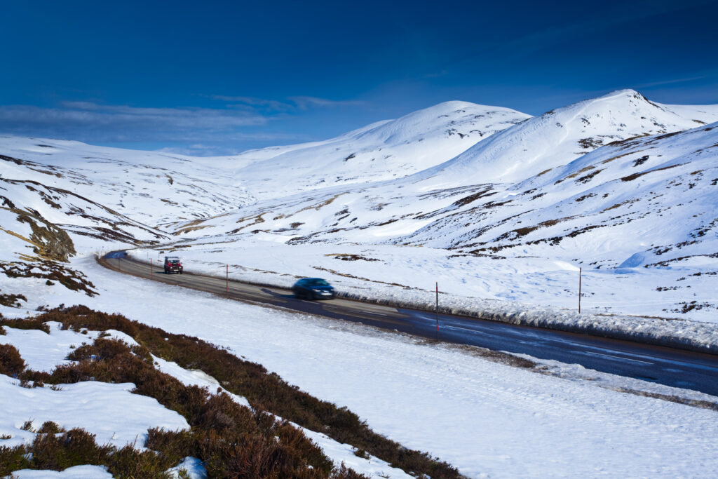 Scotland, Perthshire, Glenshee. Car and 4 wheel drive on the A93 near the Glenshee Ski Resort and the Spittal of Glenshee.