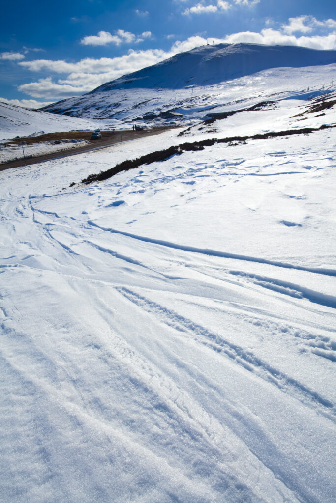 Scotland, Perthshire, Glenshee. Ski and snowboard tracks on the snow covered slopes of the Glenshee Ski Area.