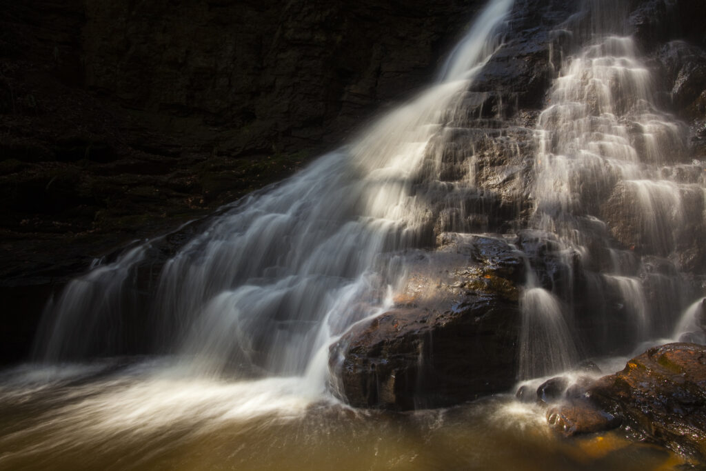England, Northumberland, Hareshaw Linn. Hareshaw Linn is a spectacular waterfall located in a steep sided gorge, which continues to flow through a wooded valley. Hareshaw Linn is located near Bellingham within the Northumberland National Park.