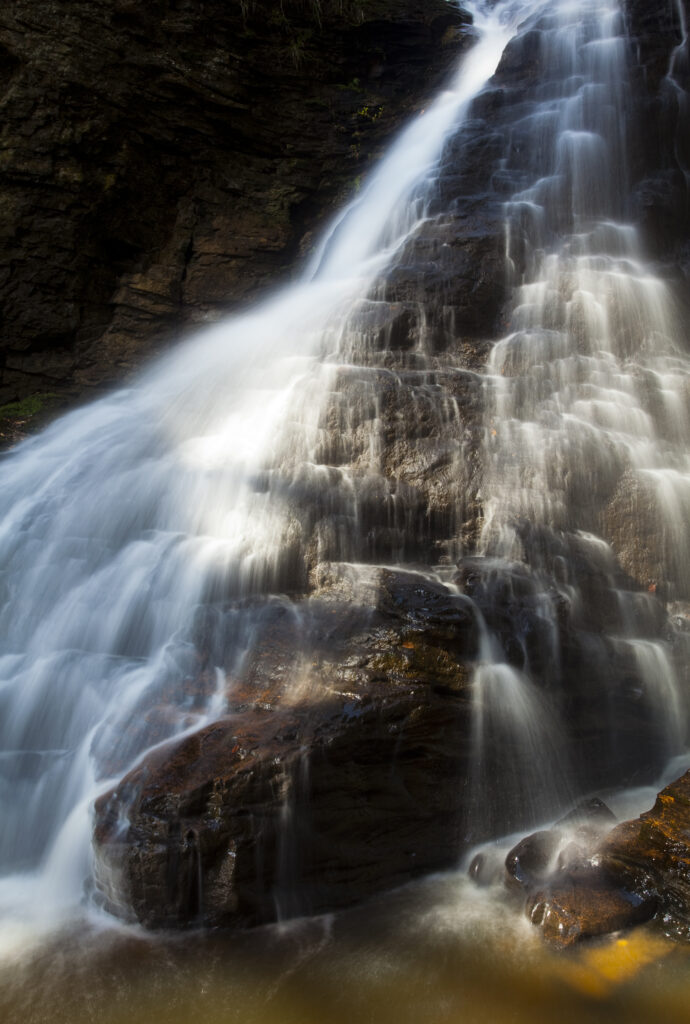 England, Northumberland, Hareshaw Linn. Hareshaw Linn is a spectacular waterfall located in a steep sided gorge, which continues to flow through a wooded valley. Hareshaw Linn is located near Bellingham within the Northumberland National Park.