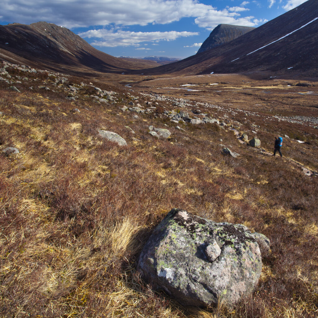 Scotland, Scottish Highlands, Cairngorms National Park. Hiker walking through the dramatic valley of the Lairig Ghru towards Braemar.