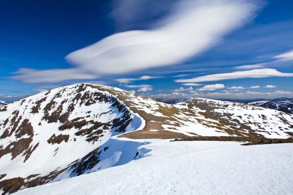 Scotland, Scottish Highlands, Cairngorms National Park. Looking towards the snow covered Cairn Toul, with the southern peaks of the National Park in the distance.
