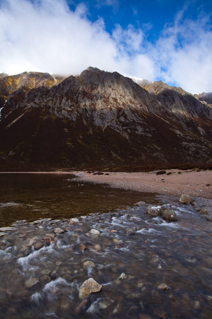 Scotland, Scottish Highlands, Cairngorms National Park. Passing light on the sheer mountain walls surrounding Loch Eanaich.