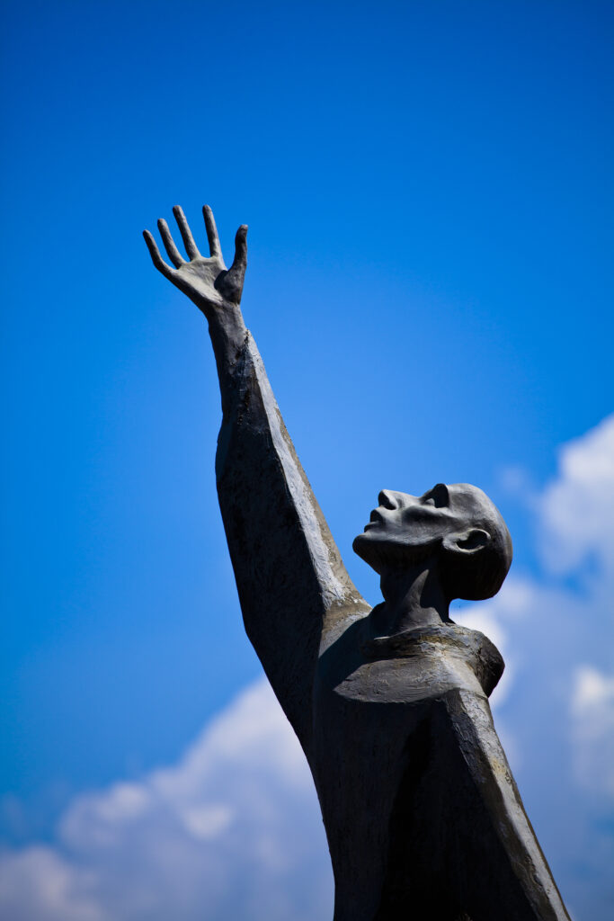Italy, Lazio, Rome. Abstract view of a statue reaching towards the sky, located near the Colosseum in Rome City.