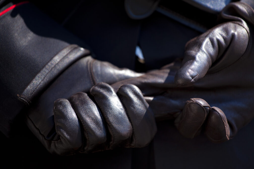 Italy, Lazio, Rome. Detail shot of hand and glove belonging to a police officer on the Piazza Quirinale in front of the Presidential Palace