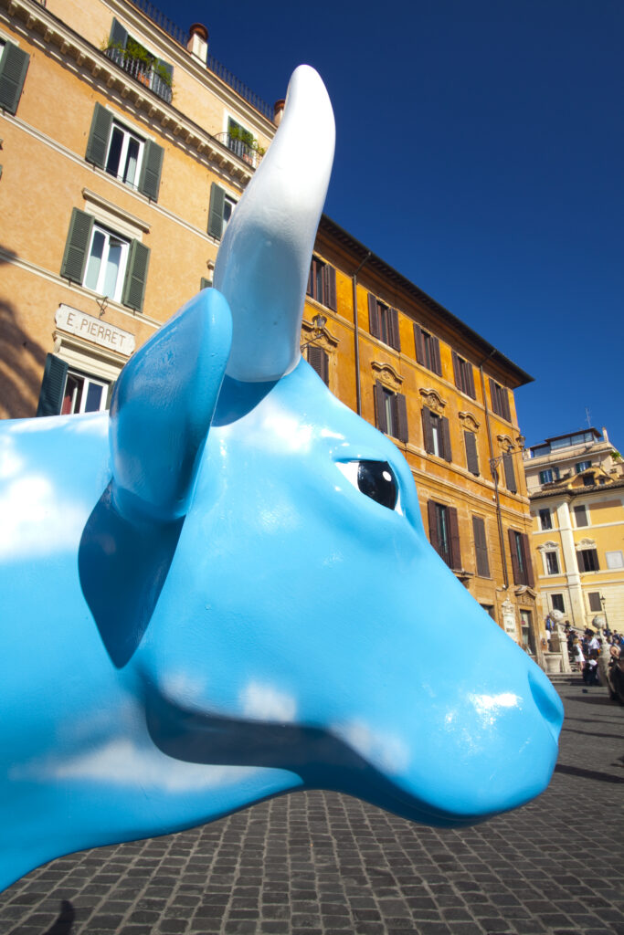 Italy, Lazio, Rome. Street exhbition known as the Cow Parade, on display throughout the city of Rome, here seen near the Spanish Steps in the famous artists' quarter of Rome.
