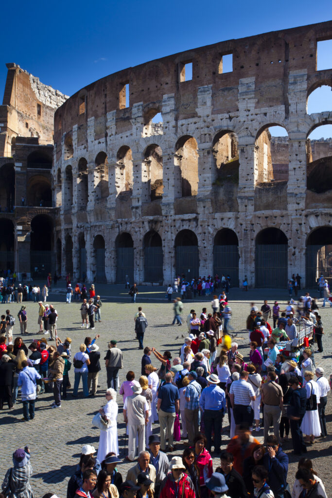 Italy, Lazio, Rome. Tourists visiting the Colosseum or Roman Coliseum, originally the Flavian Amphitheatre