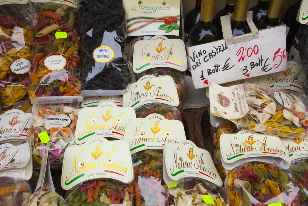 Italy, Lazio, Rome. Bags of dried pasta, wine and other italian produce on display outside a store in Rome City.