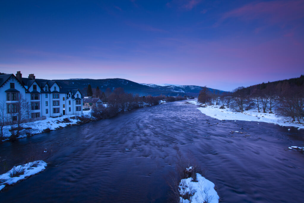 Scotland, Scottish Highlands, Cairngorms National Park. The River Dee on a stretch near the town of Ballater, viewed at dusk.