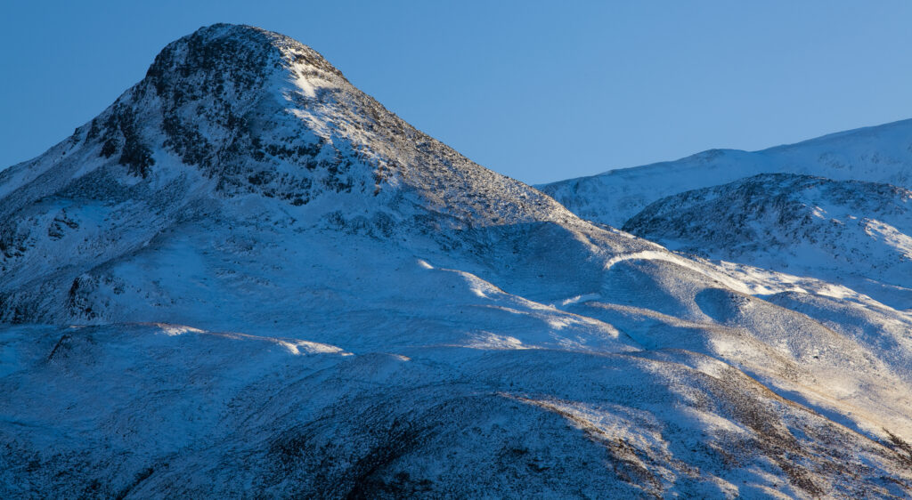 Scotland, Scottish Highlands, Glencoe. The Pap of Glencoe (Sgorr na Ciche) covered in a fresh sprinking of snow.