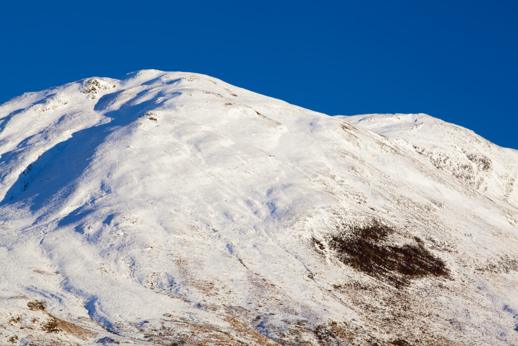 Scotland, Scottish Highlands, Glencoe. Snow covered mountain near Glencoe.