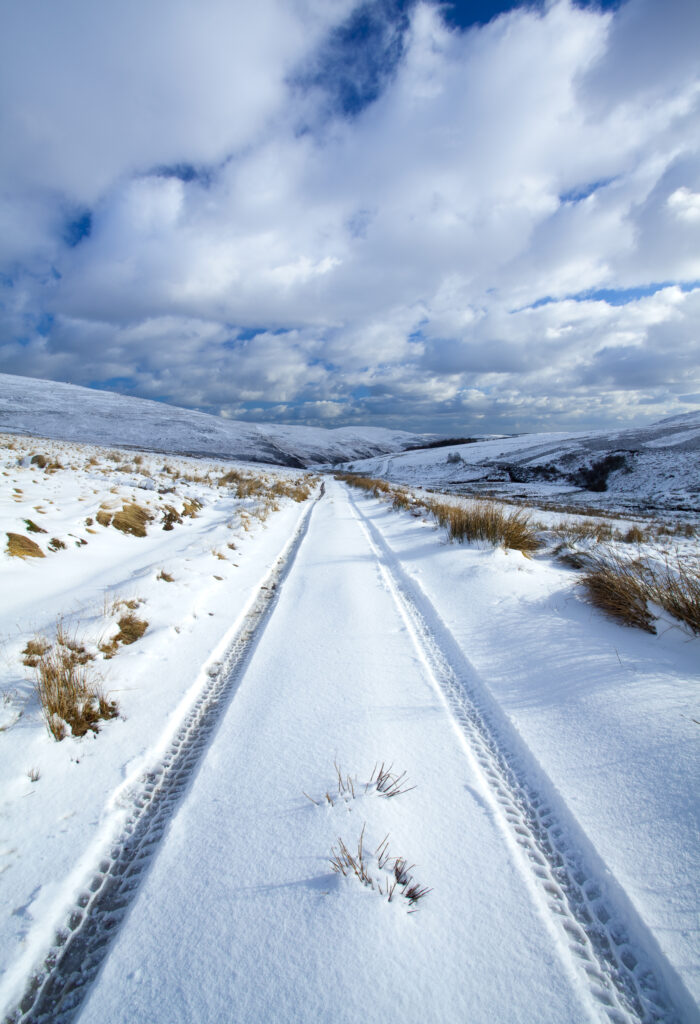 England, Northumberland, Northumberland National Park. Farm tracks running through a fresh snowfall in the Breamish Valley.