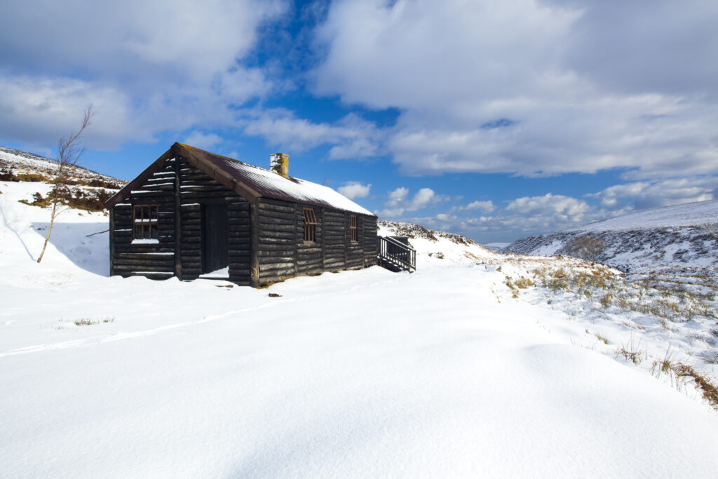 England, Northumberland, Northumberland National Park. Wooden refuge / hut in the Breamish Valley, surrounded by a fresh snowfall.