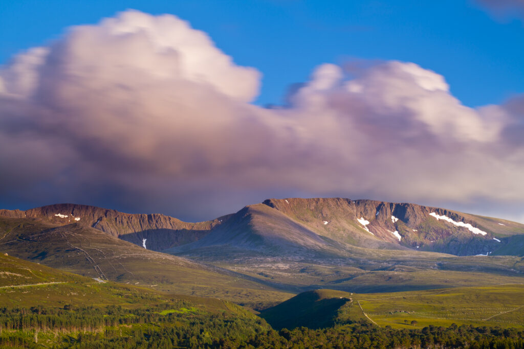 Scotland, Scottish Highlands, Cairngorms National Park. Late evening light on fast moving clouds above the Cairngorms massif.