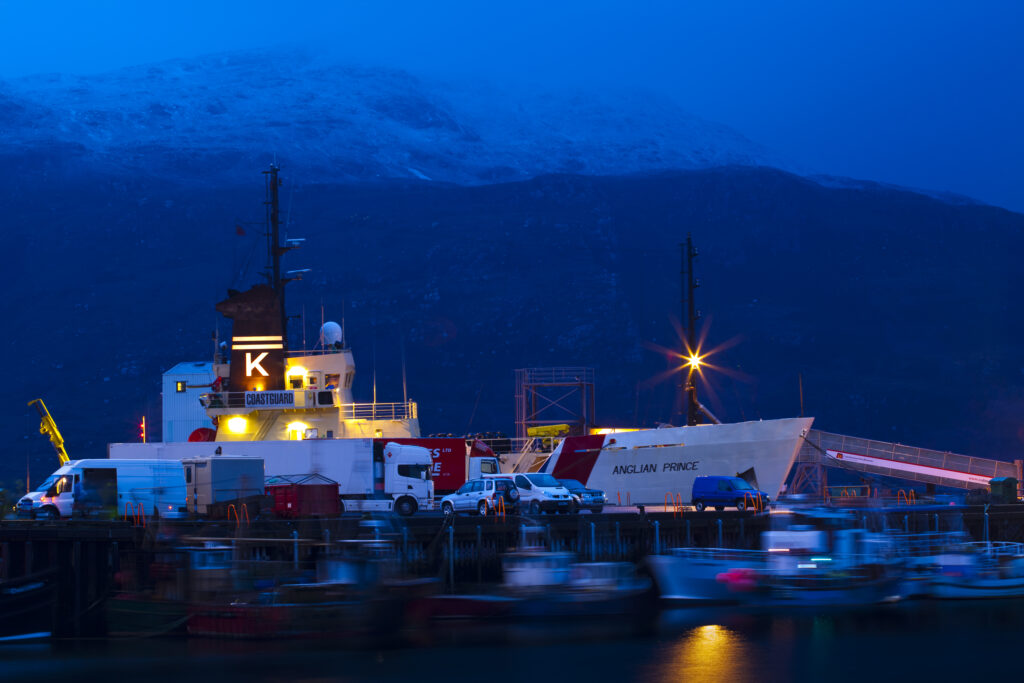 Scotland, Scottish Highlands, Ullapool. Fishing boats and coastguard ship moored in the busy port at Ullapool on the shores of Loch Broom.
