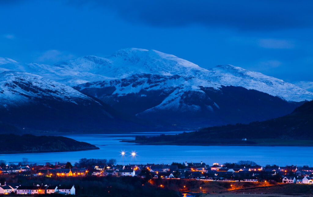 Scotland, Scottish Highlands, Ullapool. The fishing port of Ullapool located on the shores of Loch Broom, overlooked by surrounding highland mountains.