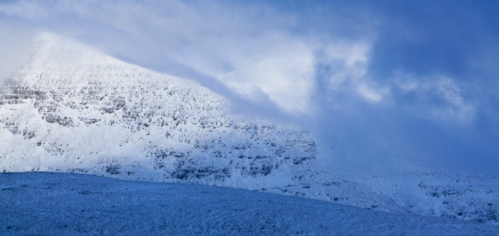 Scotland, Scottish Highlands, Assynt. Storm clouds engulf the peaks of the Assynt region.