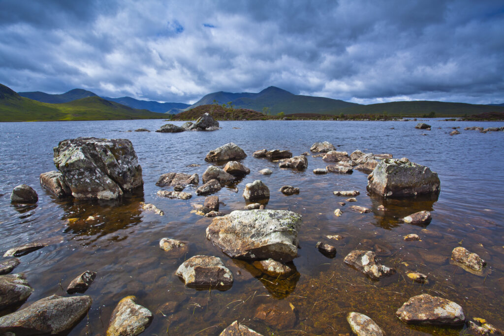 Scotland, Scottish Highlands, Rannoch Moor. Lochan an Stainge located on Rannoch Moor with the dominating peak of the Black Mount and surrounding mountains in the distance.