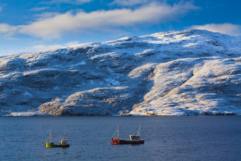 Scotland, Scottish Highlands, Ullapool. Early morning winter scene of fishing boats on Loch Broom near the port of Ullapool.