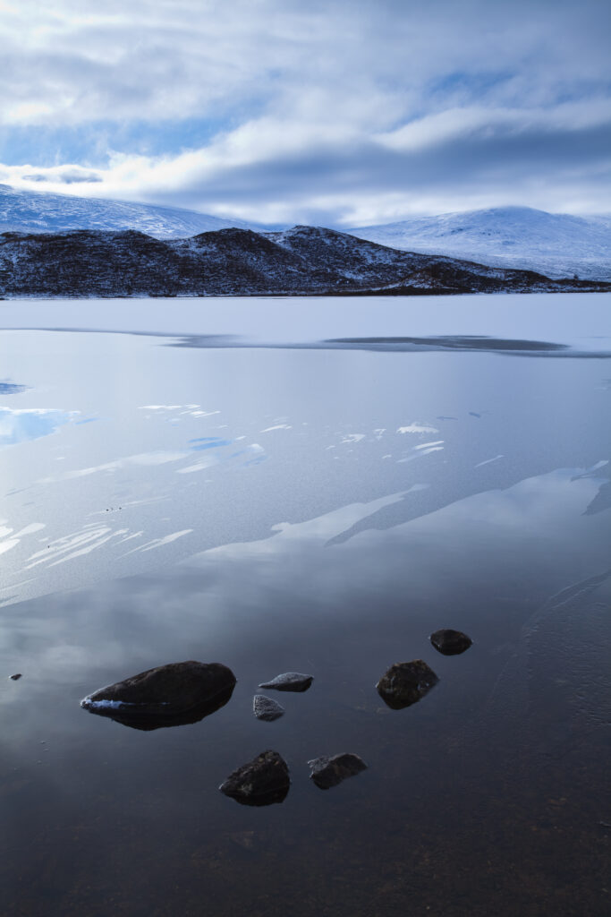 Scotland, Scottish Highlands, Loch a' Chuilinn. The subtle shades of a mid-winters day reflected upon the still face of Loch a' Chuilinn, near Lochluichart.