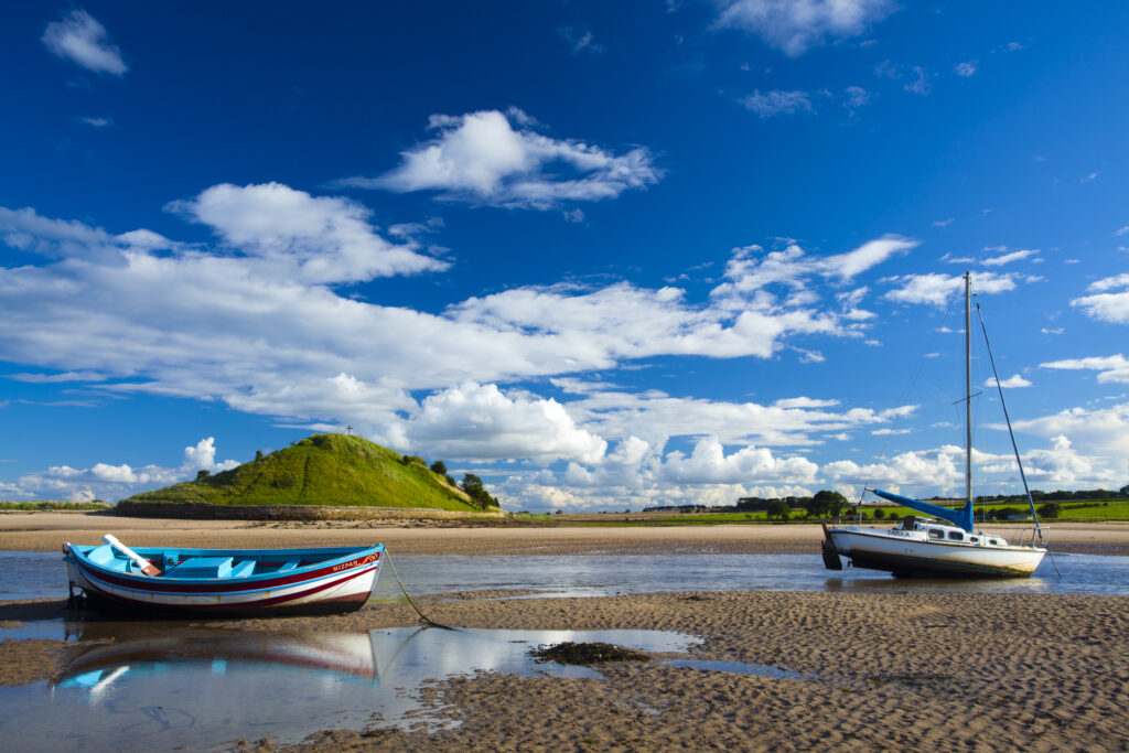 England, Northumberland, Alnmouth. Boats on the tidal Aln Estuary at Alnmouth. The hill in the distance is known as Church Hill.