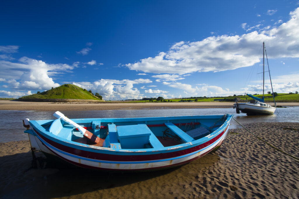 England, Northumberland, Alnmouth. Boats on the tidal Aln Estuary at Alnmouth. The hill in the distance is known as Church Hill.
