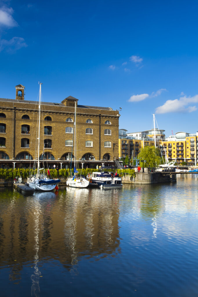 England, Greater London, London Borough of Tower Hamlets. Boats moored in the St Katharine Docks, a popular housing and leisure complex in the area known as the Docklands on the north bank of the River Thames near the London Tower Bridge.