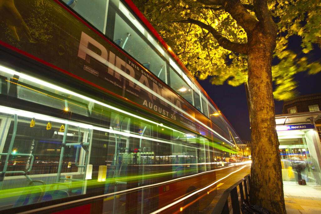England, Greater London, London Borough of Camden. Red London bus outside the London King's Cross railway station and St Pancras underground station.