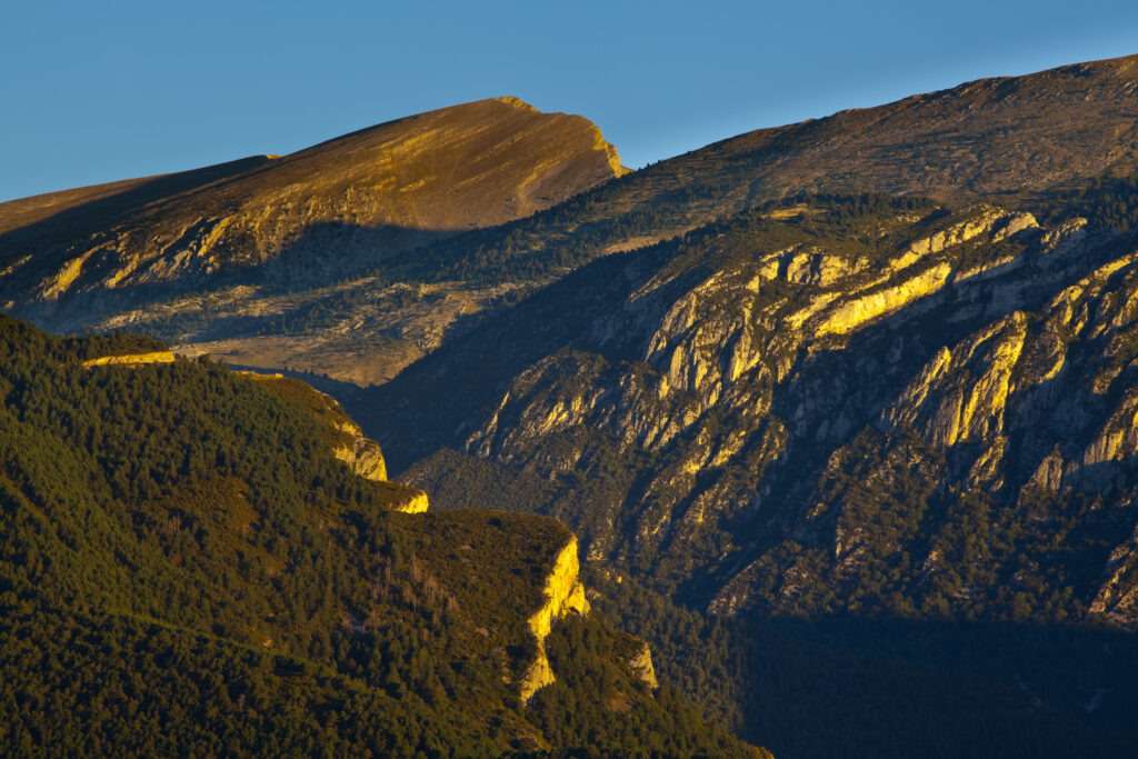 Spain, Catalonia, Pyrenees, Cadí-Moixeró Natural Park. Early morning light highlights the geological features of the Cadí-Moixeró Natural Park near Pedraforca Mountain.