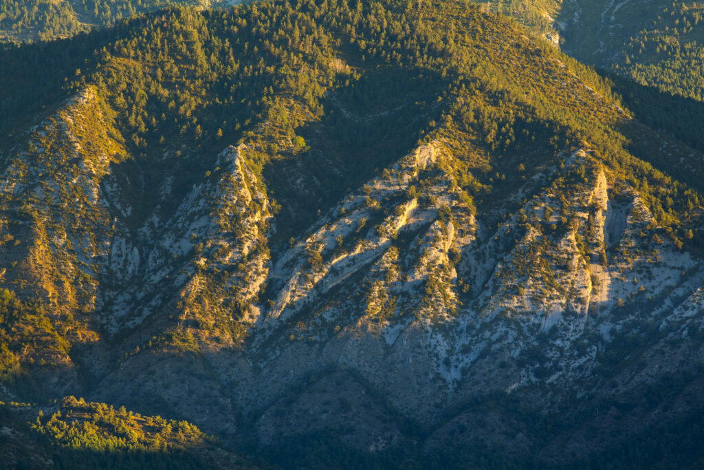 Spain, Catalonia, Pyrenees, Cadí-Moixeró Natural Park. Early morning light highlights the geological features of the Cadí-Moixeró Natural Park near Pedraforca Mountain.