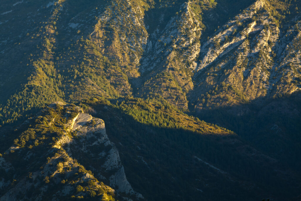 Spain, Catalonia, Pyrenees, Cadí-Moixeró Natural Park. Early morning light highlights the geological features of the Cadí-Moixeró Natural Park near Pedraforca Mountain.