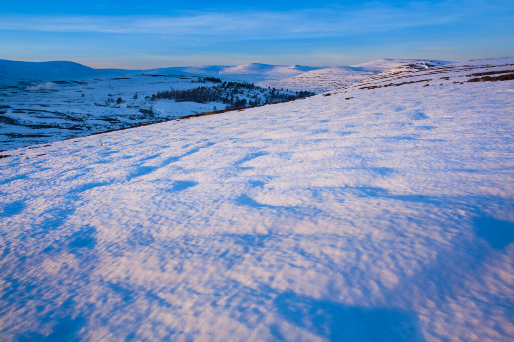 Scotland, Scottish Highlands, Cairngorms National Park. Late afternoon light illuminates the rolling eastern hills of the Cairngorms National Park.