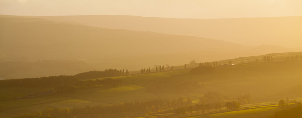 England, County Durham, Weardale. Hazy sunset over the hills of the Northern Pennines.