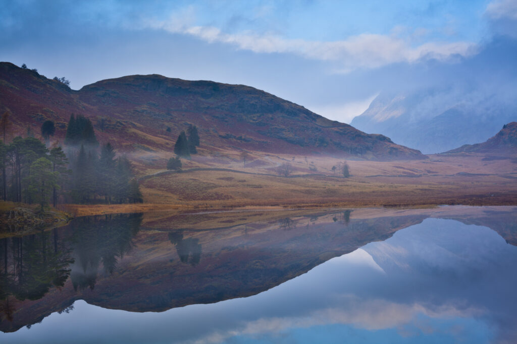 England, Cumbria, The Lake District. A misty dawn at Blea Tarn near Great Langdale.