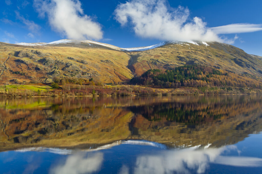 England, Cumbria, Lake District National Park. Lakeland hills reflected upon the still face of the Thirlmere Reservoir