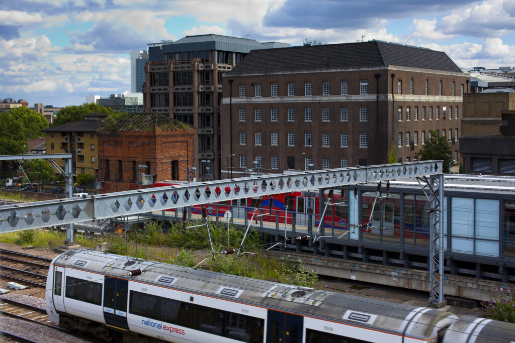 England, Greater London, Pool of London. Tower Gateway DLR station alongside the rail mainline near Tower Bridge.