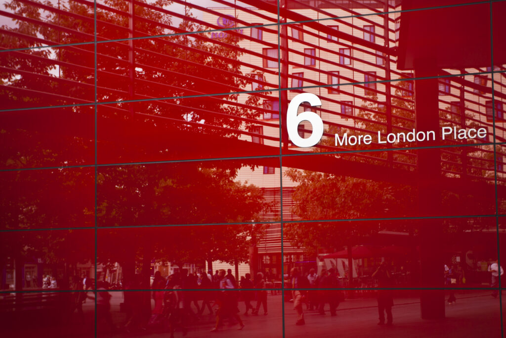 England, Greater London, Southwark. Pedestrians walking past '6 More London Place' office space development near the River Thames.