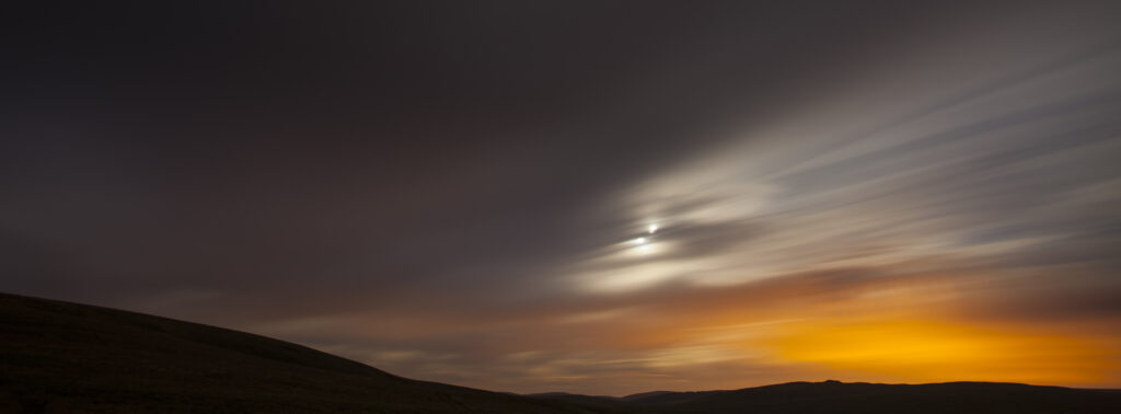 England, Northumberland, Northumberland National Park. Night time clouds move above the Northumberland Cheviot Hills near Yearning Saddle Refuge Hut.