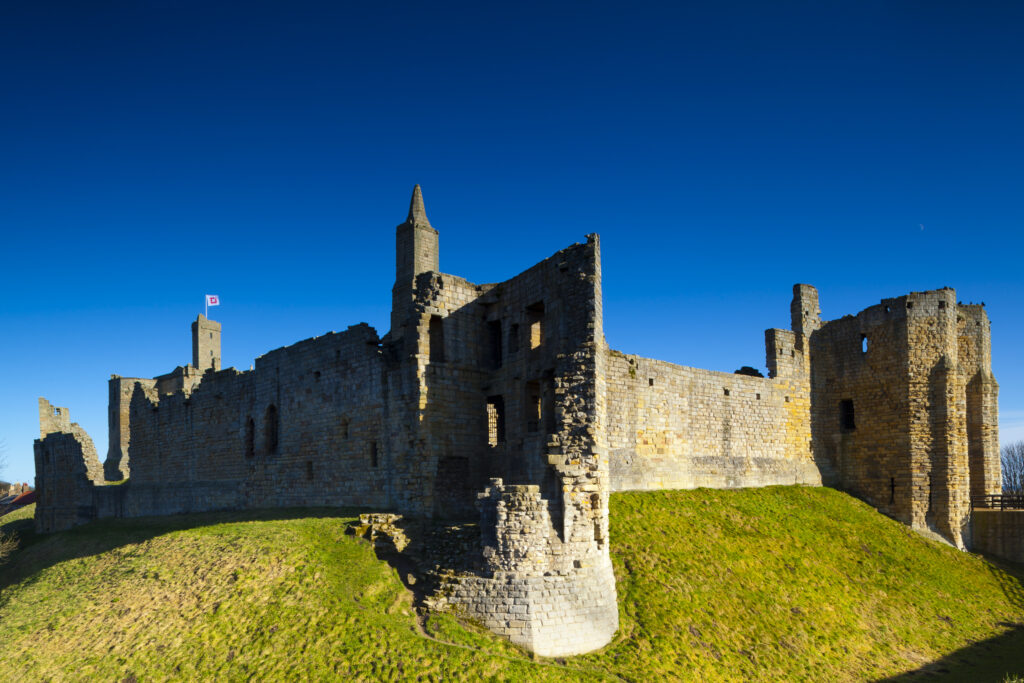 England, Northumberland, Warkworth. Warkworth Castle is a 12th-century stone motte and bailey fortress located near the Northumberland Heritage Coast.