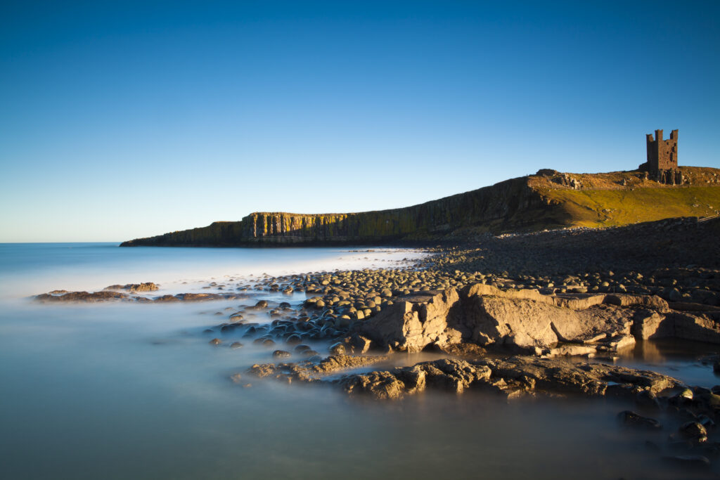 England, Northumberland, Embleton Bay. The Lilburn Tower, part of the remains of Dunstanburgh Castle, viewed from Embleton Bay.