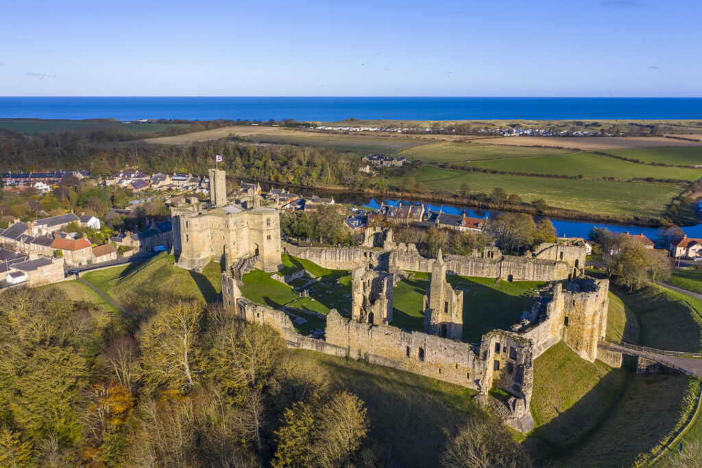 England, Northumberland, Warkworth Castle. Aerial photo of Warkworth Castle and the Northumberland Heritage Coast.